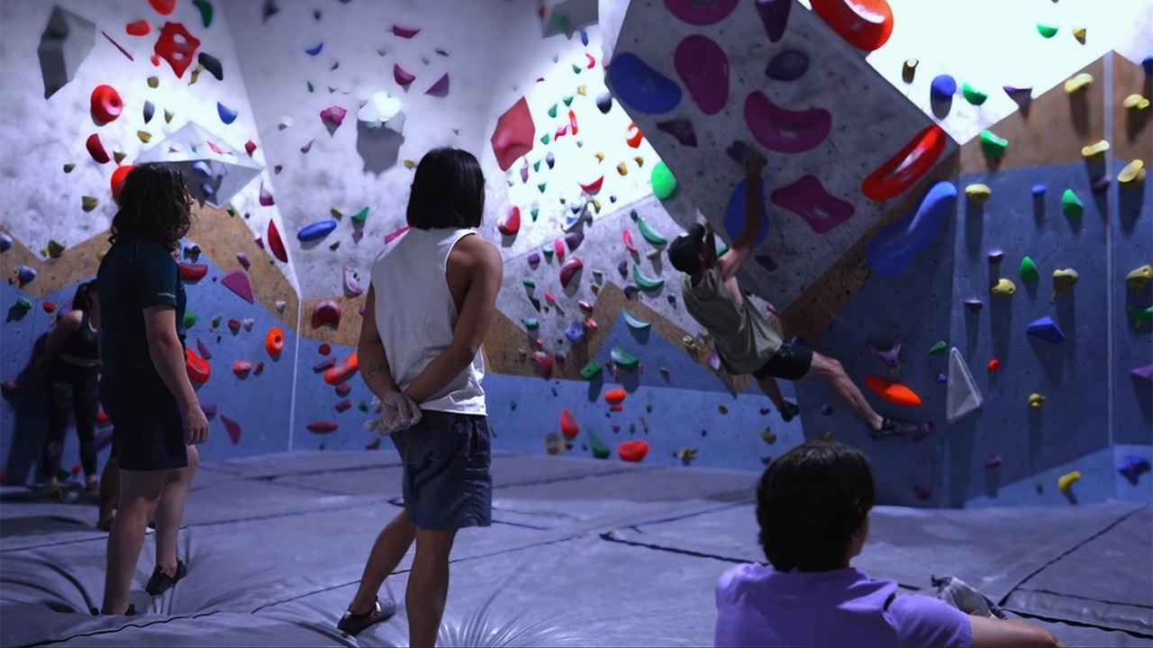 New climber learning bouldering basics at Wall Walkers