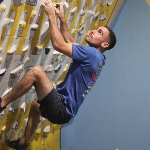 Climber crushing it on the 25 degree Moonboard